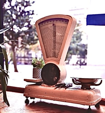 A Weight Scale For Chef’s is Positioned in the Window of an Italian Restaurant
